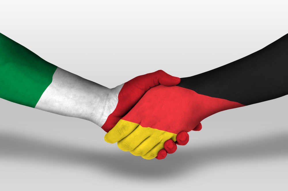 Handshake between germany and italy flags painted on hands, illustration with clipping path